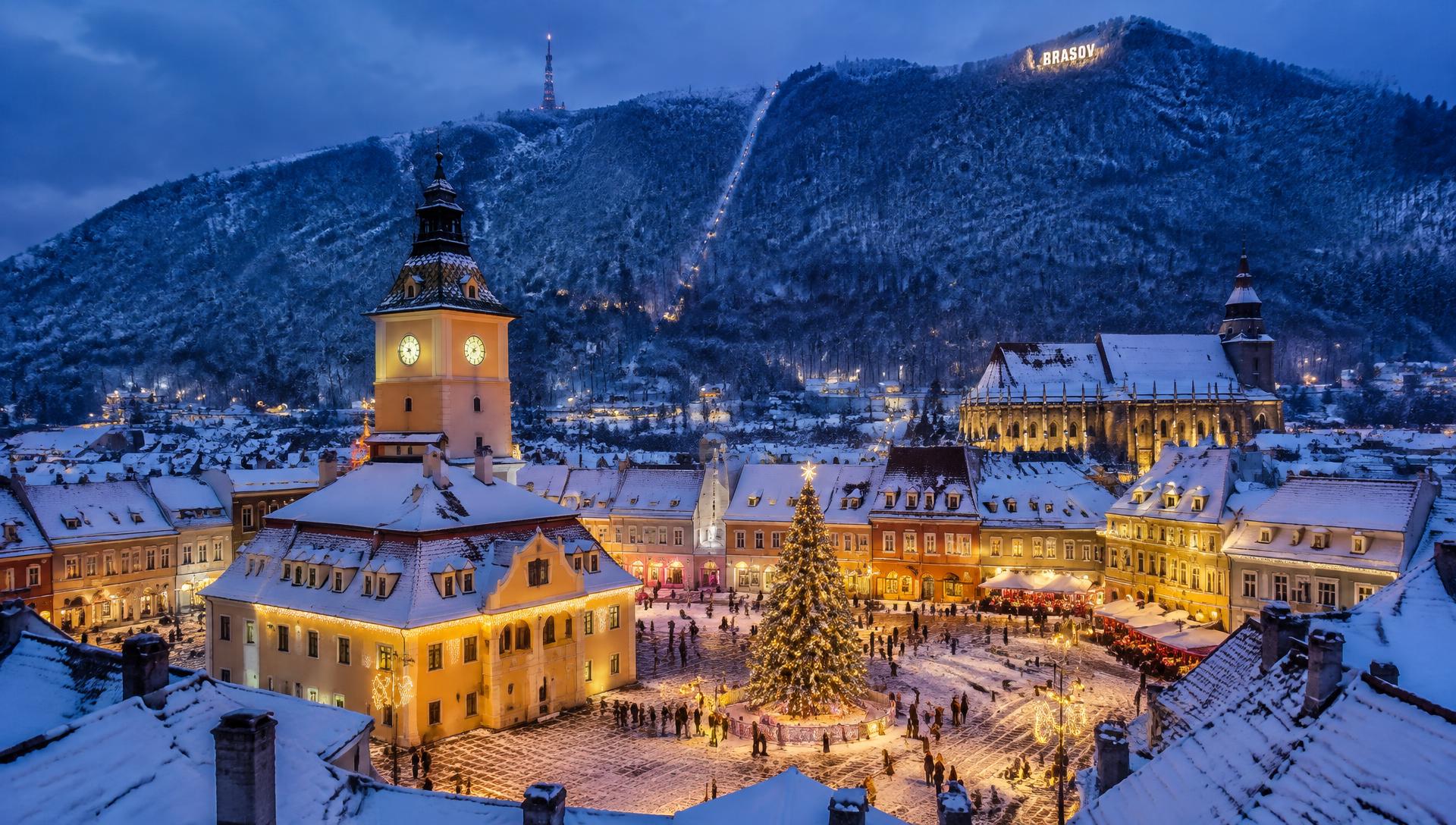Brașov Old Town and Council Square covered in snow at blue hour